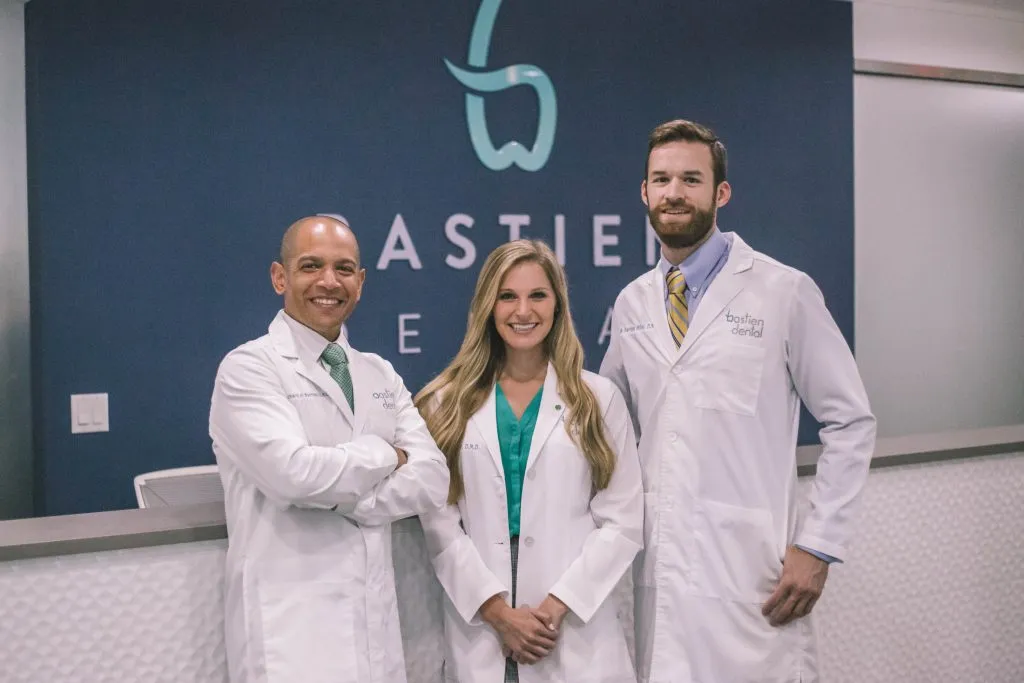 Drs. Bastien, Weir, and Miller standing in the office